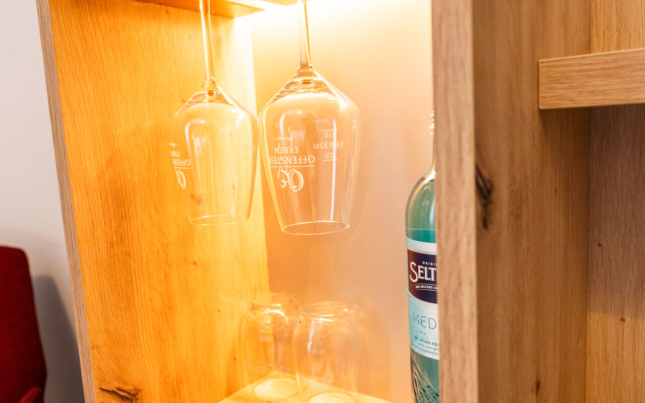 Gläser und Flasche in Holzregal